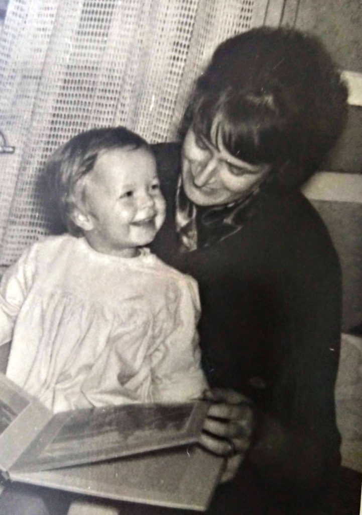 Slovenian painter Irina Rahovsky Kralj with her older daughter Tamara Kralj (married Jare) slovenian painter in art studio reading art book in 1964 in Ljubljana fine art studio art gallery